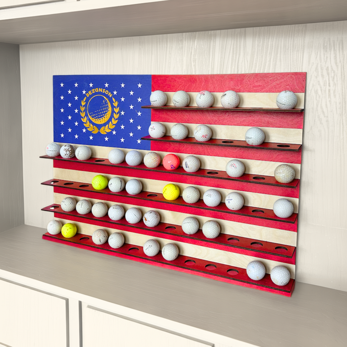 Golf ball display rack with American flag design on a wall.