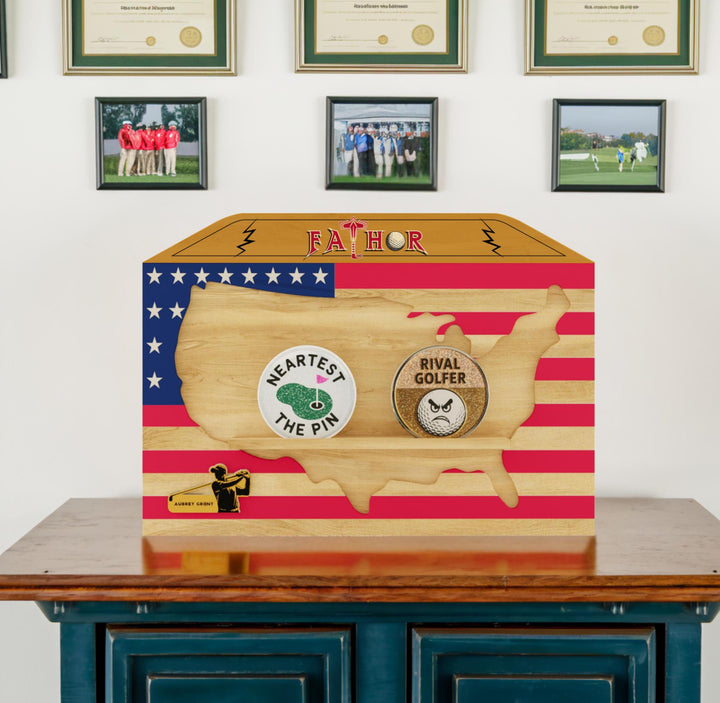 Wooden box with USA map design on a wooden surface with framed pictures in the background.