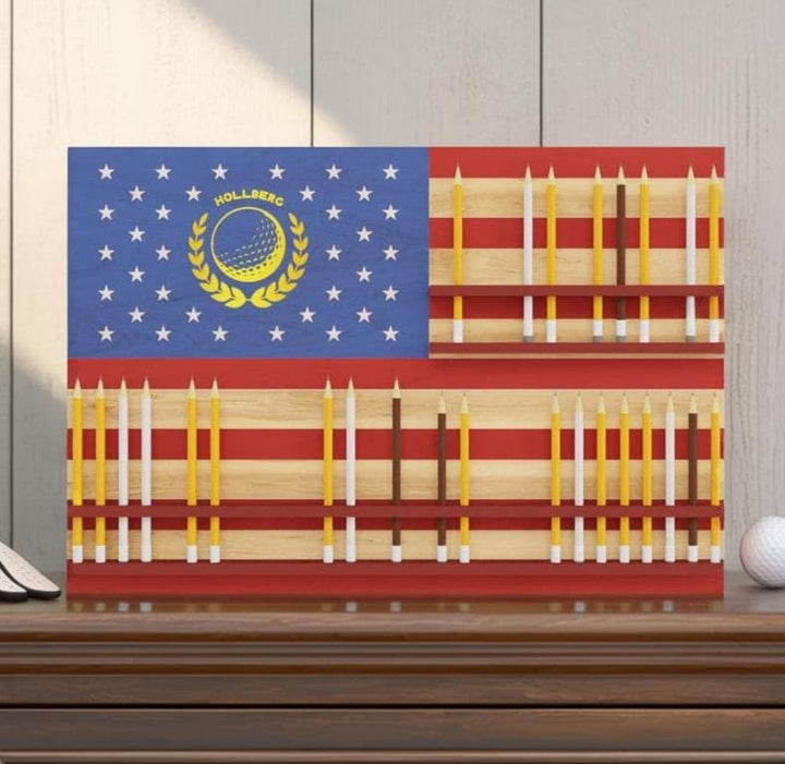 Decorative wall art resembling an American flag with golf-themed elements on a wooden surface.