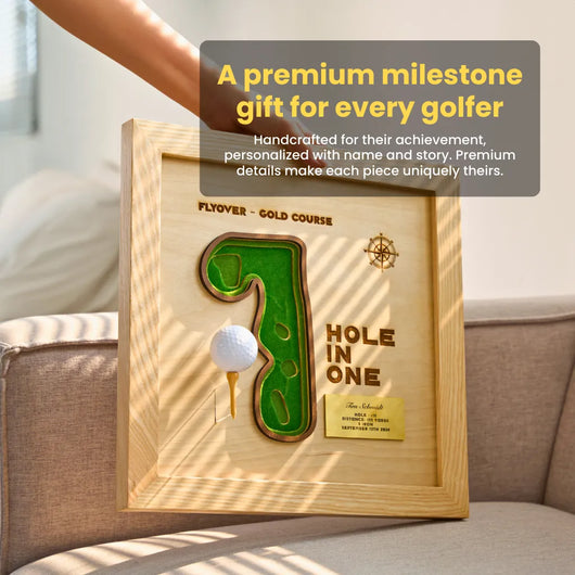 Framed golf-themed artwork with 'Hole in One' design on a couch.