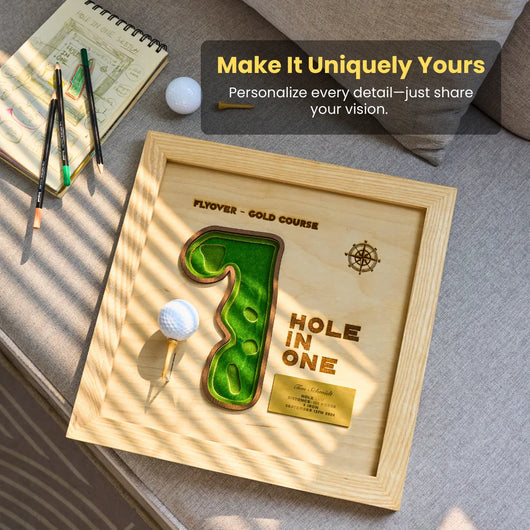 Wooden plaque with golf design and text on a surface with stationery items.