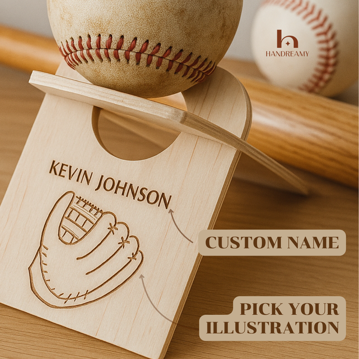 Wooden plaque with engraved name 'Kevin Johnson' and illustration of a baseball glove, placed on a wooden stand with a baseball and bat in the background.