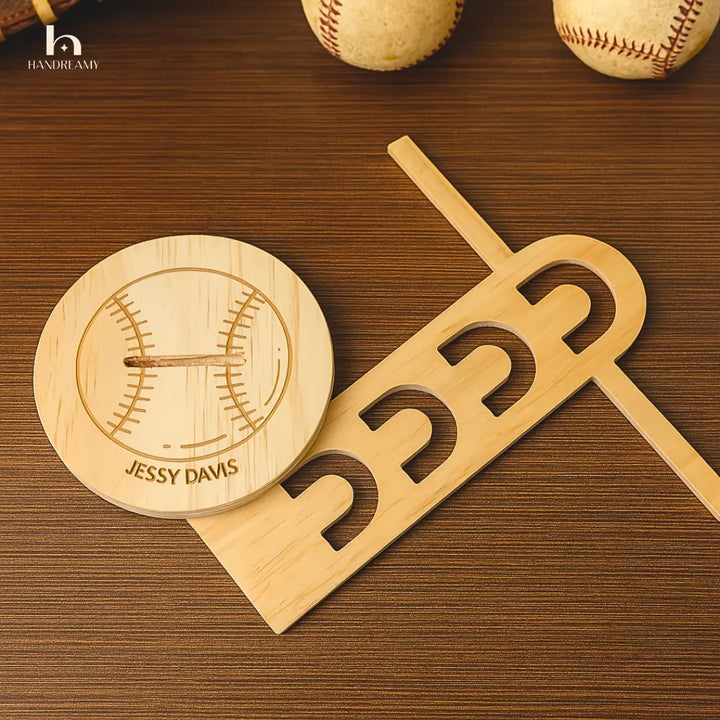 Wooden baseball bat and helmet with engraved name on a wooden surface