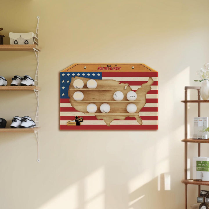 Wooden wall art with American flag design and baseballs on a beige wall.