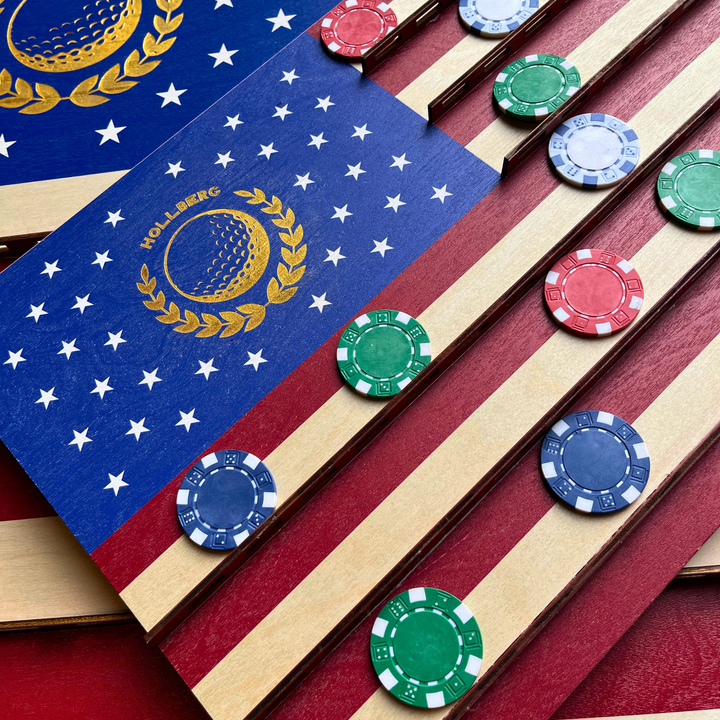 Poker chips on an American flag-themed surface with a logo.