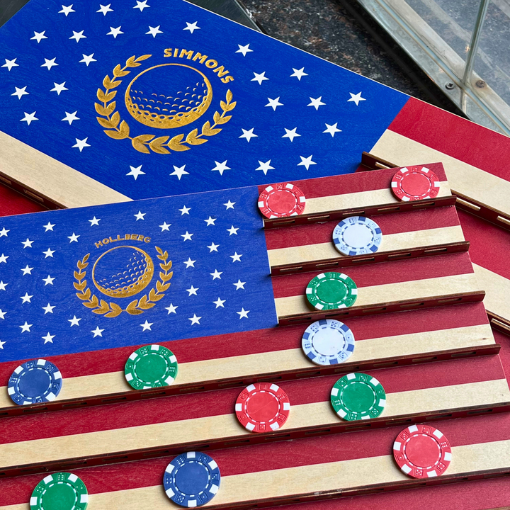 American flag-themed wooden game board with golf ball design and colorful chips.