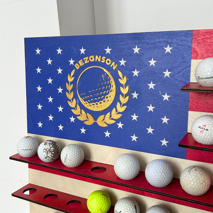 Golf ball return machine with Bezanson logo and golf balls on a white background