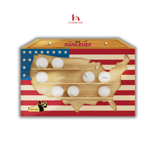 Wooden wall art shaped like the United States with embedded golf balls on an American flag background, featuring the brand 'Handimamy'.