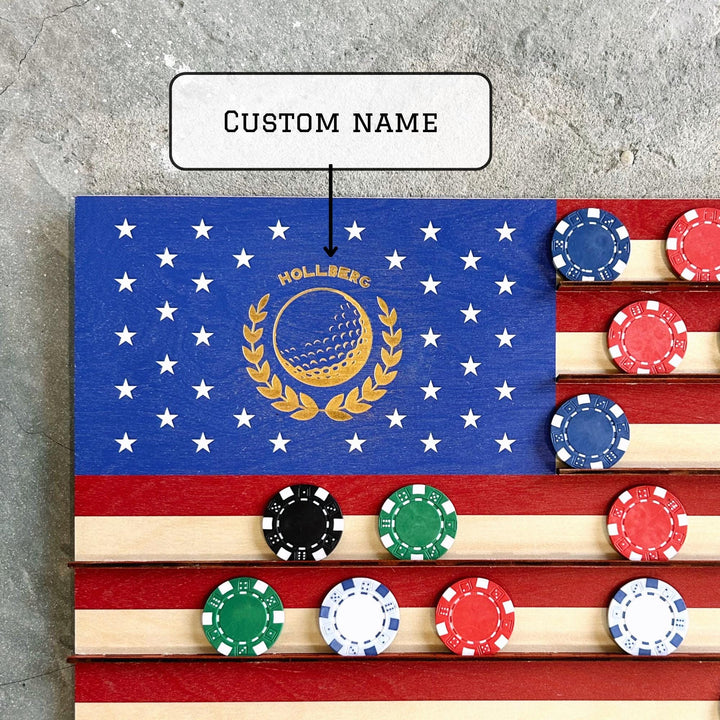 Wooden flag with golf-themed design and poker chips on a gray surface