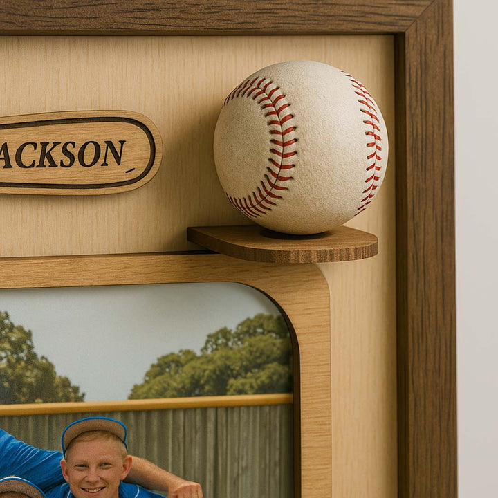 Baseball on a wooden shelf with a framed picture of a man in a blue shirt and cap.