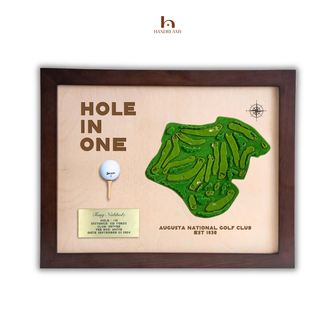 Framed golf-themed artwork with 'Hole in One' text and golf club design.