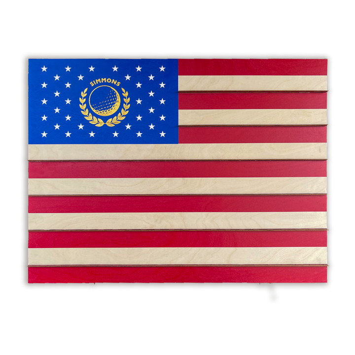 A wooden golf ball marker display case with a design resembling the US flag, featuring a stars and stripes pattern.